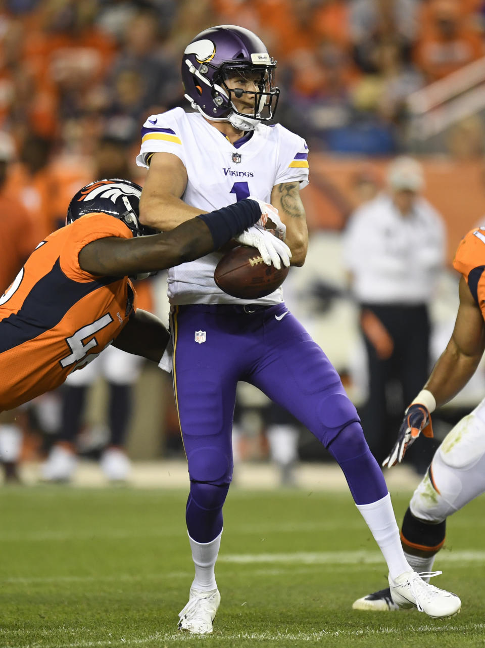 Denver Broncos linebacker Jeff Holland, left, sacks Minnesota Vikings quarterback Kyle Sloter during the second half in an NFL football preseason game Saturday, Aug. 11, 2018, in Denver. (AP Photo/Mark Reis)