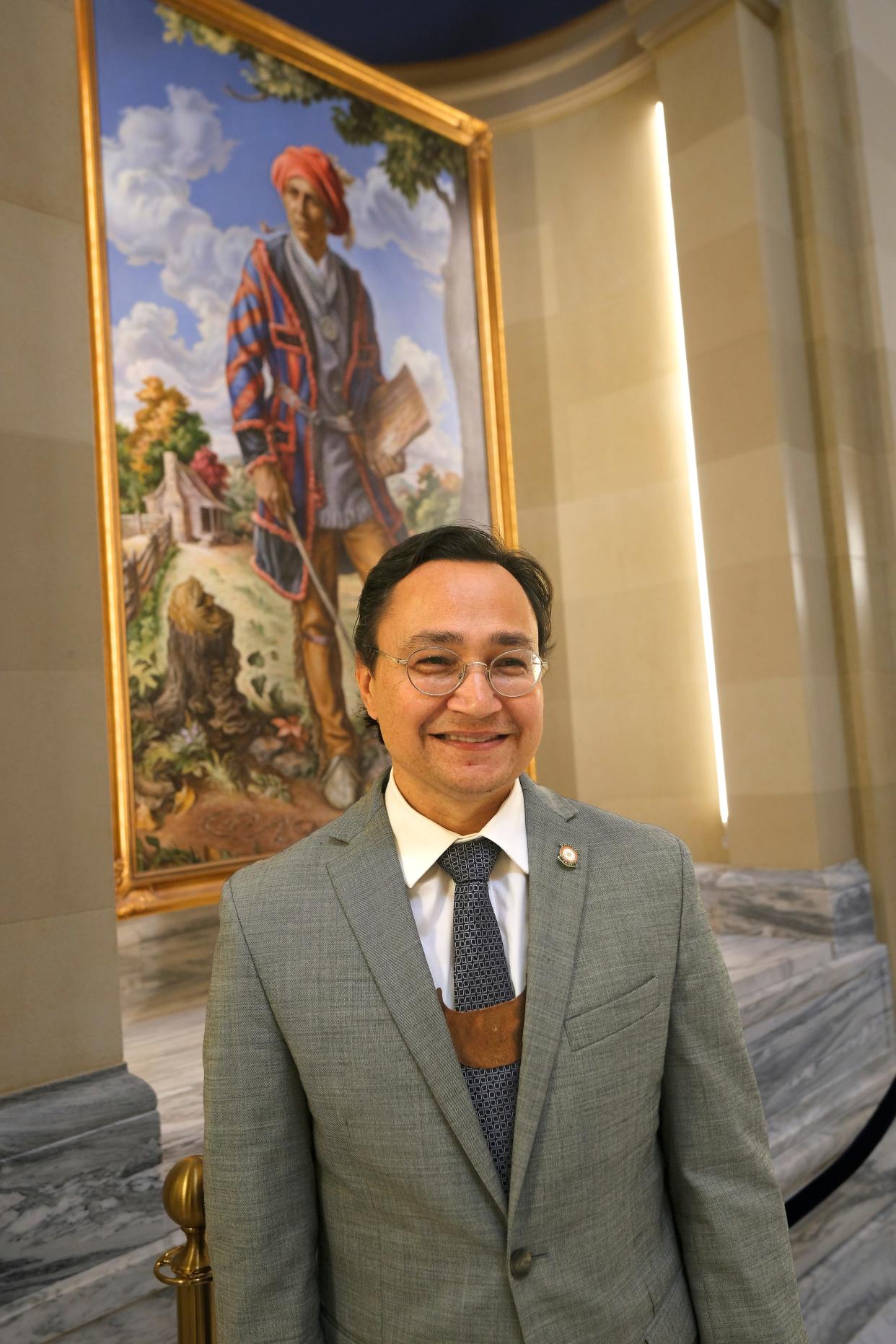 Cherokee Nation Principal Chief Chuck Hoskin Jr. poses for a photo in front of the portrait of Sequoyah at the Oklahoma Capitol, Tuesday, Nov. 7, 2023
