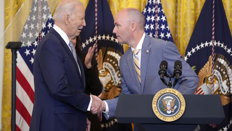 Utah Gov. Spencer Cox, right, greets President Joe Biden before he speaks to the National Governors Association during an event in the East Room of the White House on Friday, Feb. 23, 2024, in Washington.