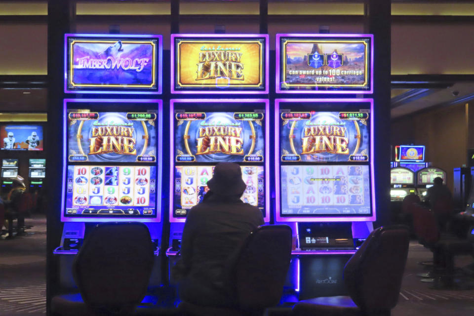 A gambler plays a slot machine at Harrah's casino in Atlantic City, N.J. on Sept. 29, 2023. On Jan, 16, 2023, New Jersey gambling regulators released statistics showing that Atlantic City's casinos, racetracks that accept sports betting and their online partners won nearly $5.8 billion from gamblers in 2023, a new record. But only three of the nine casinos won more from in-person gamblers last year than they did in 2019 before the coronavirus pandemic broke out. (AP Photo/Wayne Parry)