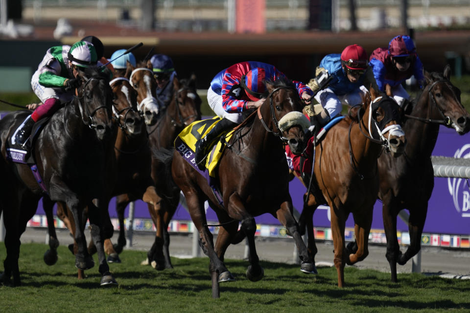 Tom Marquand rides Big Evs, center, to win the Breeders' Cup Juvenile Turf Sprint horse race Friday, Nov. 3, 2023 at Santa Anita Park in Arcadia, Calif. (AP Photo/Ashley Landis)