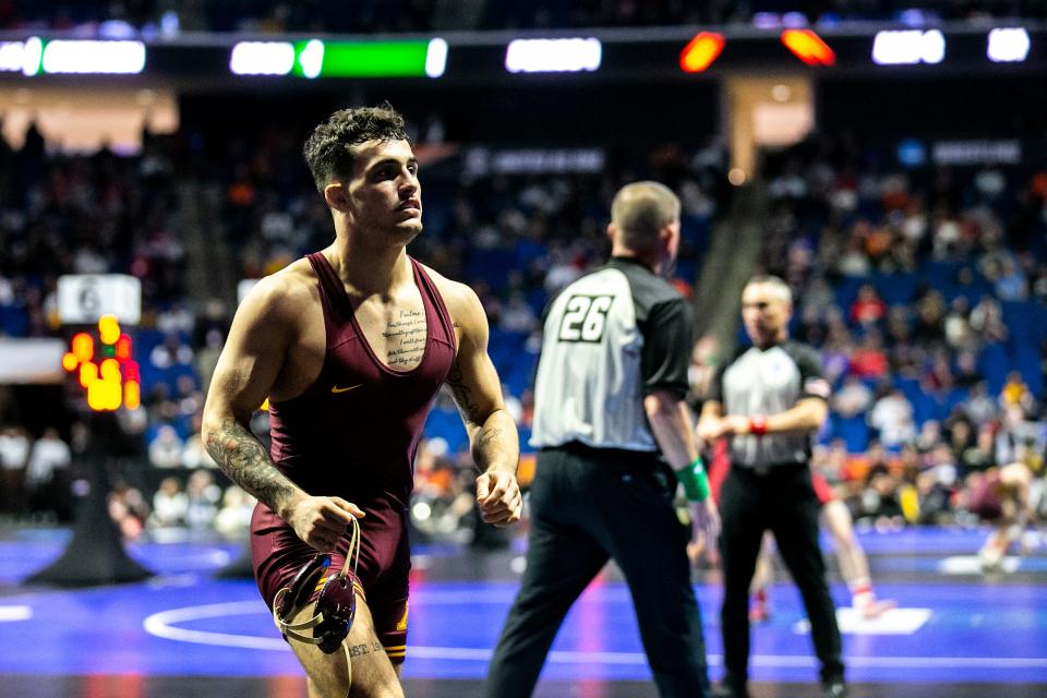 Minnesota's Michael Blockhus runs of the mat after his match at 149 pounds during the first session of the NCAA Division I Wrestling Championships, Thursday, March 16, 2023, at BOK Center in Tulsa, Okla.