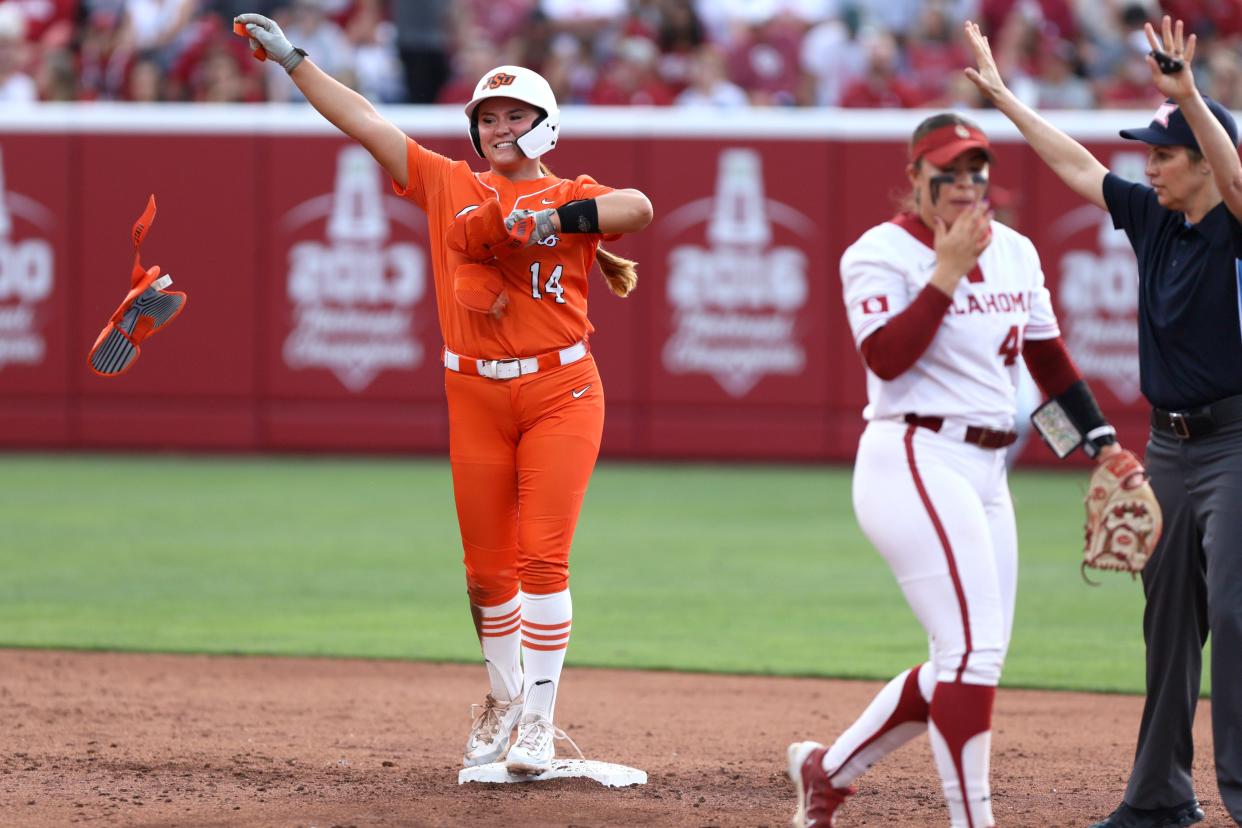 Oklahoma State infielder Karli Godwin (14) celebrates after driving in two runs on a double in the thrd inning of a Bedlam softball game between the University of Oklahoma Sooners (OU) and the Oklahoma State Cowgirls (OSU) at Love's Field in Norman, Okla., Friday, May 3, 2024. Oklahoma State won 6-3.