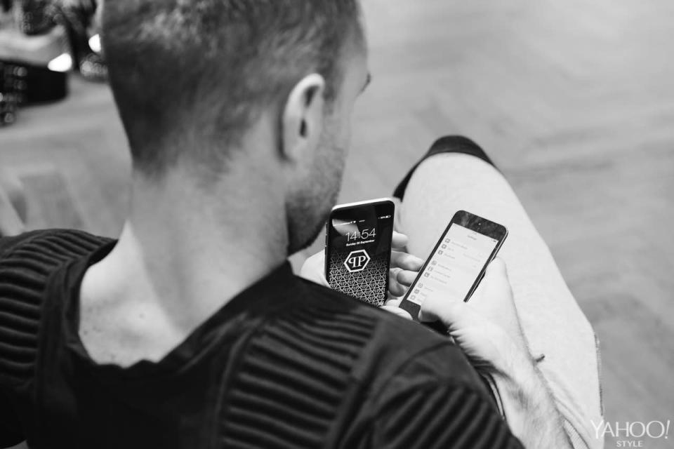 Phillip Plein juggles two phones in the run-up to his spring 2016 show at Milan Fashion Week. (Photo: Matteo Cherubino.)