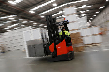 A fork lift truck driver moves white goods at the PC World and Carphone Warehouse distribution centre in Newark, Britain November 21, 2017. REUTERS/Darren Staples