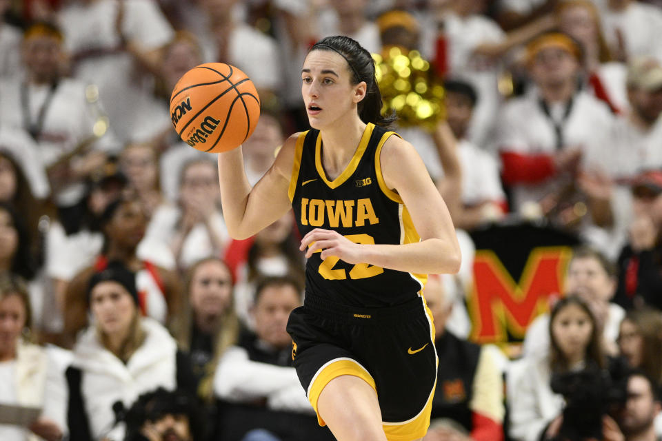 Iowa guard Caitlin Clark dribbles during the first half of an NCAA college basketball game against Maryland, Saturday, Feb. 3, 2024, in College Park, Md. (AP Photo/Nick Wass)