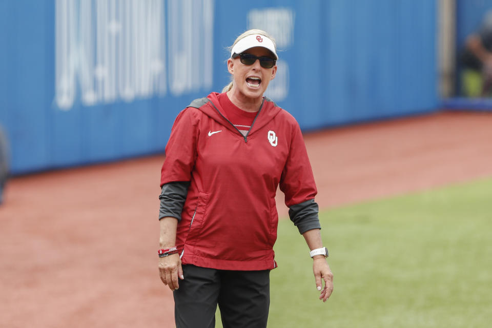 FILE - Oklahoma head coach Patty Gasso yells to the team in the first inning of an NCAA softball Women's College World Series game against Northwestern on June 2, 2022, in Oklahoma City. The Sooners have won five of the past nine national championships. Oklahoma could add another rare accolade this season by becoming the first program since UCLA from 1988 to 1990 to win three consecutive titles. (AP Photo/Alonzo Adams, File)