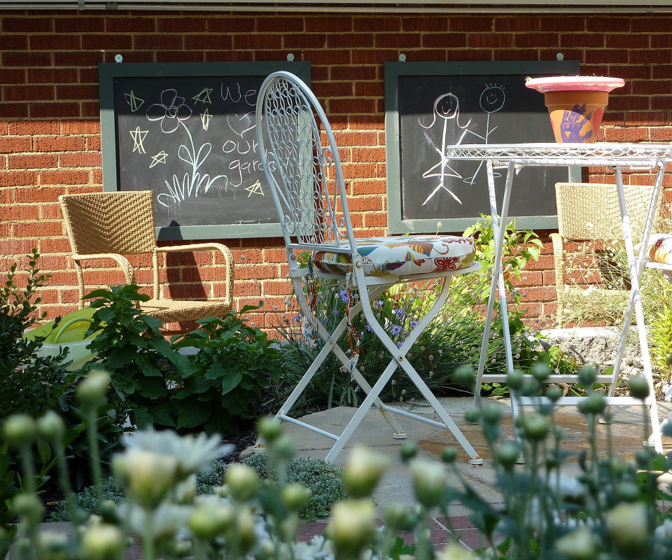 chalkboards on a wall next to a patio seating area