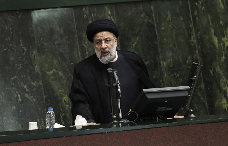 President Ebrahim Raisi defends his proposed ministers in a session of parliament, in Tehran, Iran, Wednesday, Aug. 25, 2021. Iran's hard-liner dominated parliament Wednesday voted to approve most of the proposed ministers of the newly elected president. (AP Photo/Vahid Salemi)