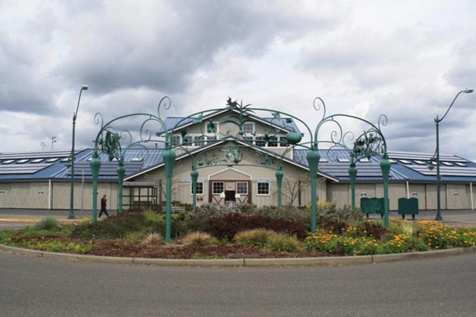 Throughout 2021, Looking Back is featuring events and people from the Sylvester’s Window cityscape project, now available online. The 2001 cityscape features the Olympia Farmers Market, near the northern tip of the Port of Olympia. The market, one of the largest in Puget Sound, was built at this location in 1996. Photograph selected and captioned by Deborah Ross on behalf of the Olympia Historical Society and Bigelow House Museum. For more information, see https://olympiahistory.org/2001-2/