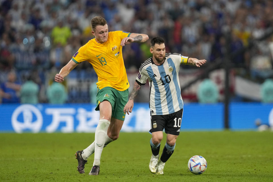 Australia's Harry Souttar chases Argentina's Lionel Messi during the World Cup round of 16 soccer match between Argentina and Australia at the Ahmad Bin Ali Stadium in Doha, Qatar, Saturday, Dec. 3, 2022. (AP Photo/Thanassis Stavrakis)