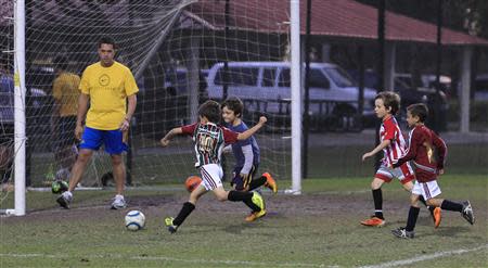 Young soccer team members take part in a practice at a publicly-funded field in Weston, Florida November 14, 2013. REUTERS/Joe Skipper