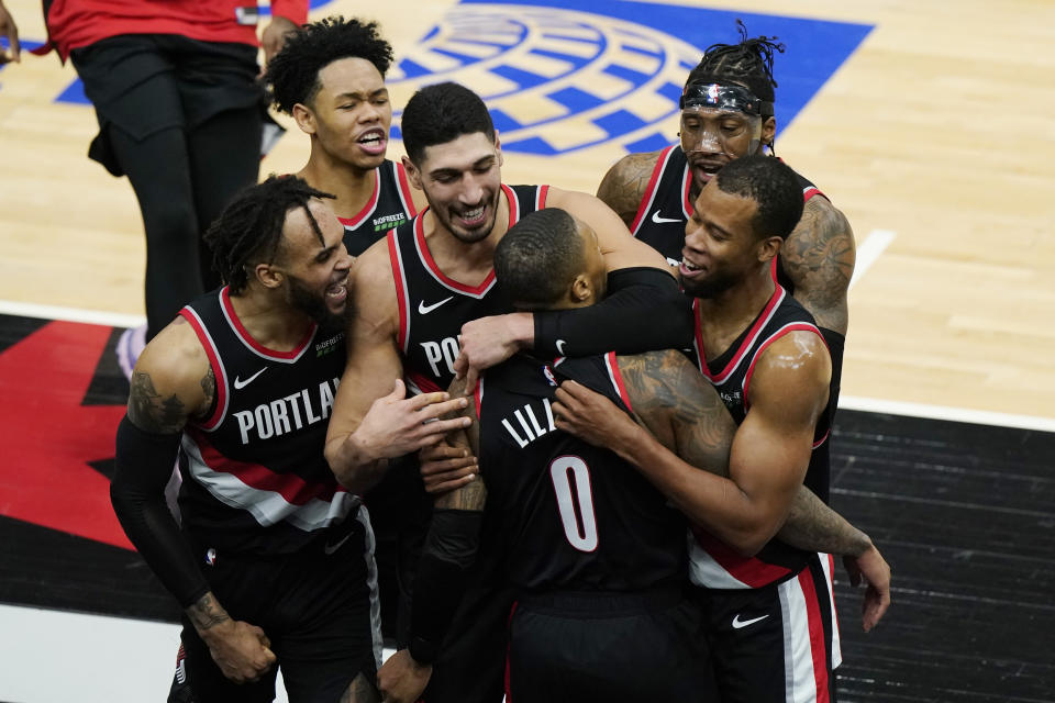 Portland Trail Blazers guard Damian Lillard (0) celebrates with teammates after making the winning three-point basket during the second half of an NBA basketball game against the Chicago Bulls in Chicago, Saturday, Jan. 30, 2021. (AP Photo/Nam Y. Huh)
