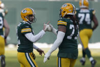 Green Bay Packers quarterback Aaron Rodgers is congratulated by teammate Billy Turner (77) after Rodgers' touchdown pass to Marquez Valdes-Scantling against the Tampa Bay Buccaneers during the first half of the NFC championship NFL football game in Green Bay, Wis., Sunday, Jan. 24, 2021. (AP Photo/Matt Ludtke)