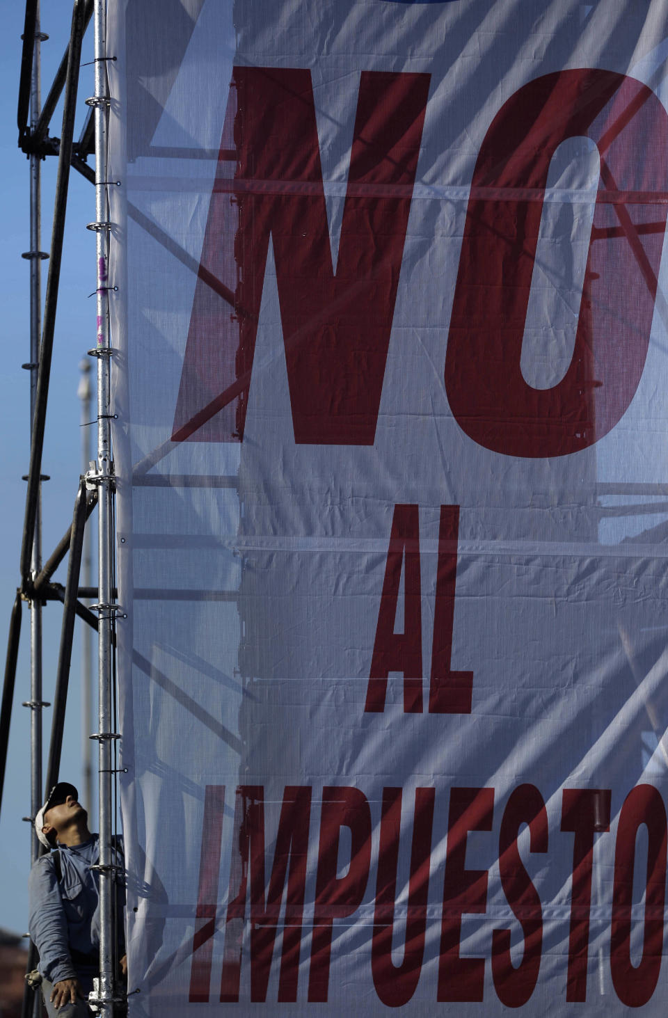 A sign that reads in Spanish "No to income tax" hangs during a protest at Plaza de Mayo in Buenos Aires, Argentina, Wednesday, June 27, 2012. A strike and demonstration called by union leader Hugo Moyano demands steps that would effectively reduce taxes on low-income people, among other measures. (AP Photo/Natacha Pisarenko)