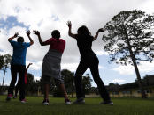 In this Tuesday, Sept. 24, 2019, photo, girls dance as they do exercises at a shelter for migrant teenage girls, in Lake Worth, Fla. (AP Photo/Wilfredo Lee)