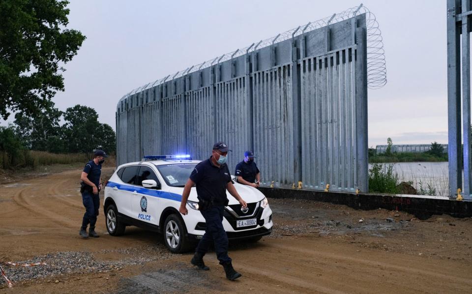 Greek police patrol a new 5-metre steel fence installed along the Evros River by the border with Turkey - Byron Smith /Getty Images Europe 