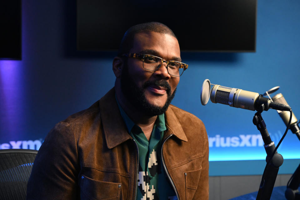 Close-up of Tyler smiling in front of a microphone