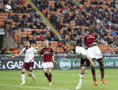 AC Milan forward Mario Balotelli, right, scores a goal during the Serie A soccer match between AC Milan and Livorno at the San Siro stadium in Milan, Italy, Saturday, April 19, 2014. (AP Photo/Antonio Calanni)