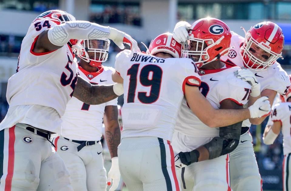 Georgia tight end Brock Bowers (19) is congratulated by his teammates after a touchdown during the Bulldogs 45-0 win over Georgia Tech Saturday in Atlanta.