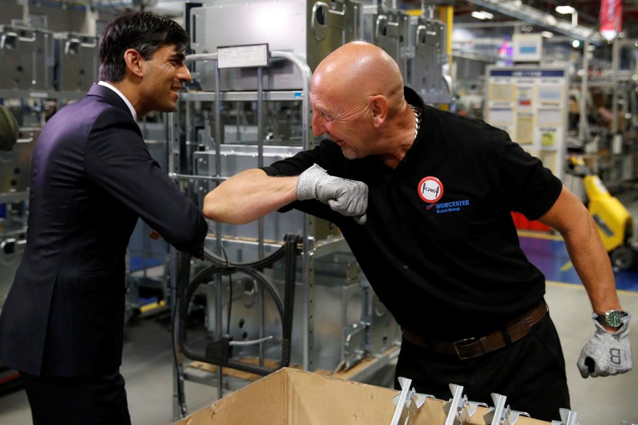 Elbow bump: Rishi Sunak greets a worker on his visit to a boiler factory in Worcester today. He said he was prepared to make "difficult decisions" over borrowing: POOL/AFP via Getty Images