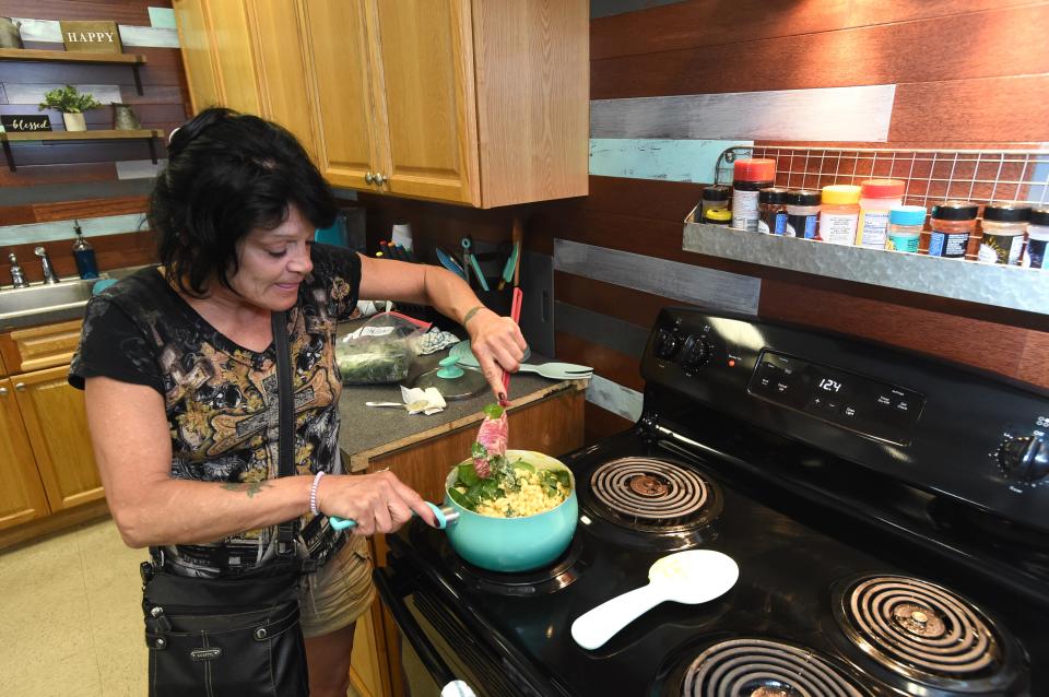 Wendy Rommel-Petito prepares lunch for her and some of the other residents of the women's area of One Hopeful Place last year.