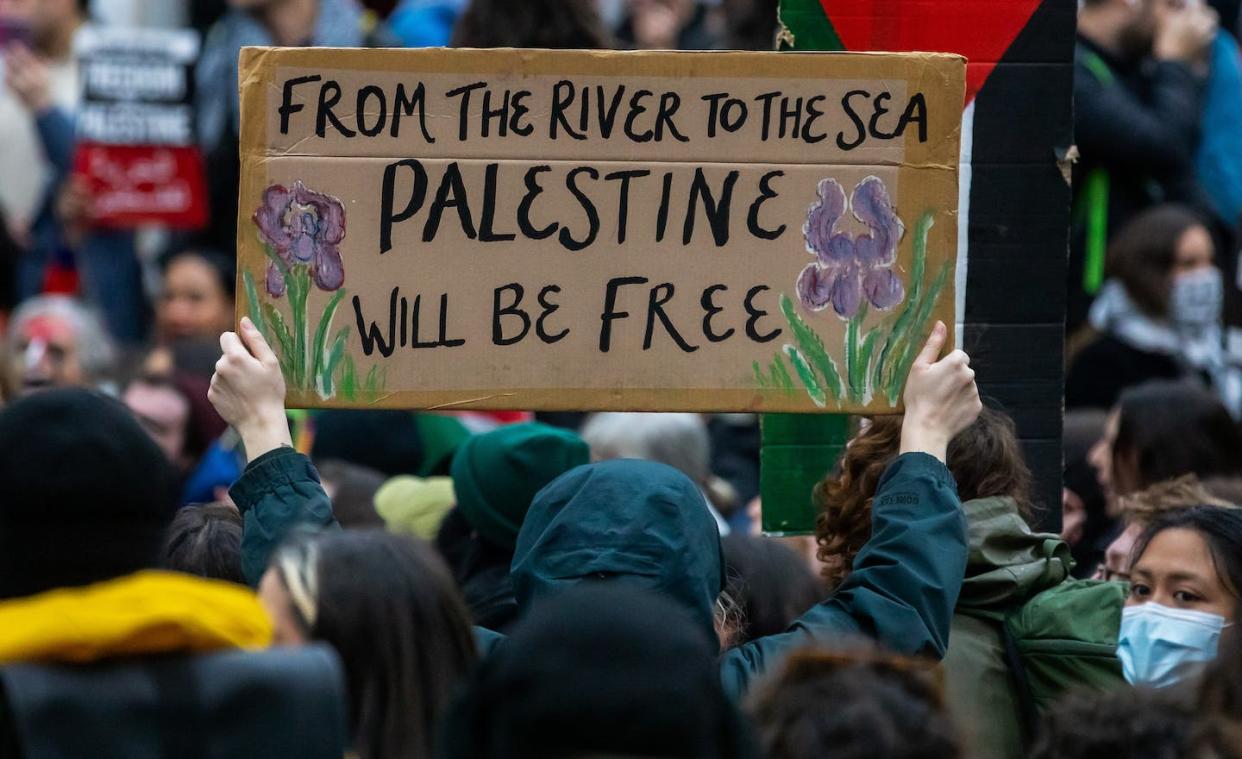 A pro-Palestinian activist in the U.K. <a href="https://www.gettyimages.com/detail/news-photo/pro-palestinian-activist-holds-up-a-sign-reading-from-the-news-photo/1767735727?adppopup=true" rel="nofollow noopener" target="_blank" data-ylk="slk:Mark Kerrison/In Pictures via Getty Images;elm:context_link;itc:0;sec:content-canvas" class="link ">Mark Kerrison/In Pictures via Getty Images</a>