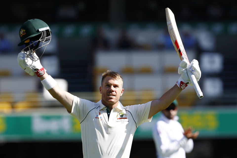 Australia's David Warner celebrates after scoring 100 runs during their cricket test match against Pakistan in Brisbane, Australia, Friday, Nov. 22, 2019. (AP Photo/Tertius Pickard)