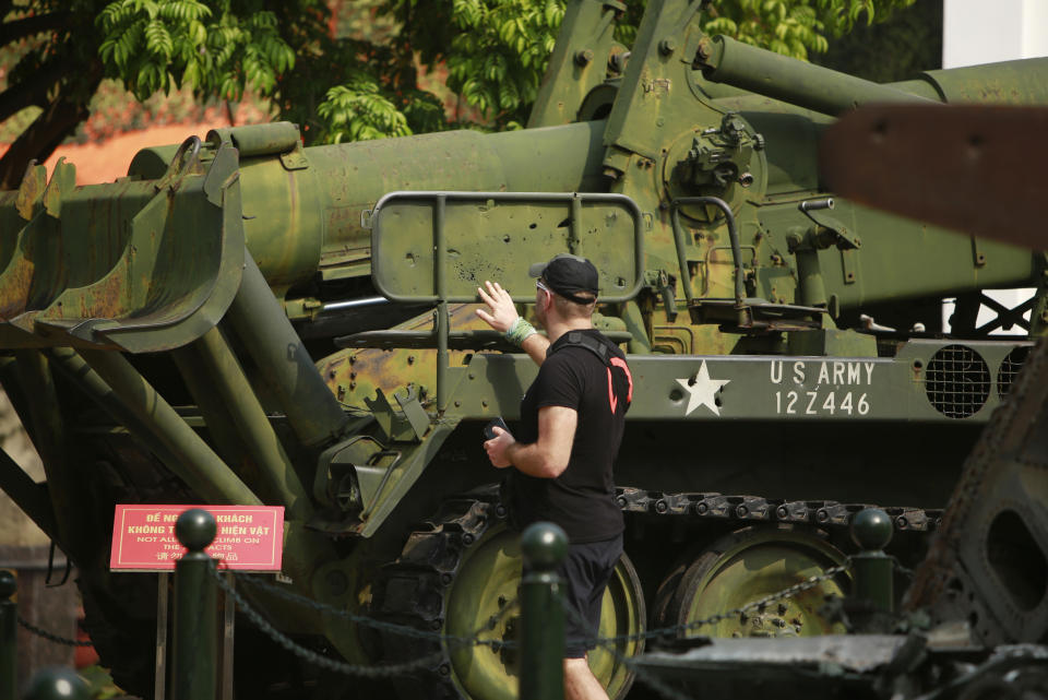 In this Feb. 21, 2019, photo, a visit touches bullet holes on an American artillery launcher at Vietnam Military History Museum in Hanoi, Vietnam. The Vietnamese capital once trembled as waves of American bombers unleashed their payloads, but when Kim Jong Un arrives here for his summit with President Donald Trump he won’t find rancor toward a former enemy. Instead, the North Korean leader will get a glimpse at the potential rewards of reconciliation. (AP Photo/Hau Dinh)