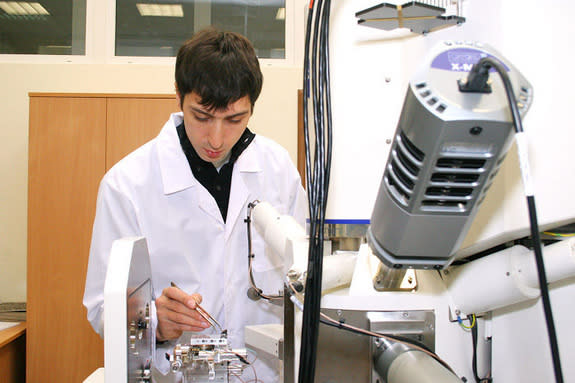 A Ural Federal University scientist works with a small fragment thought to be a meteorite from the Feb. 15, 2013, fireball over the Chelyabinsk region.