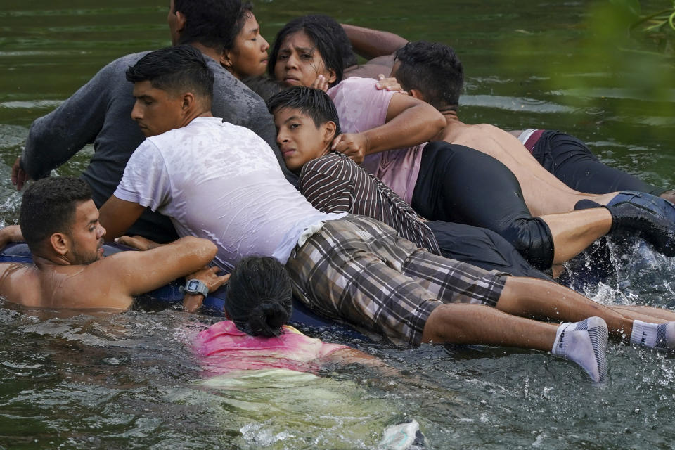 FILE - Migrants cross the Rio Grande river on an inflatable mattress to the U.S., from Matamoros, Mexico, May 9, 2023. (AP Photo/Fernando Llano, File)