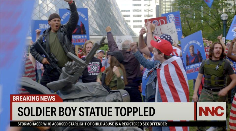 A fallen statue for Soldier Boy seen on the news in season three of "The Boys."