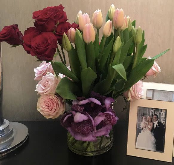 The first picture posted was of flowers which were places on a table with a wedding picture. Source: Roxy Jacenko