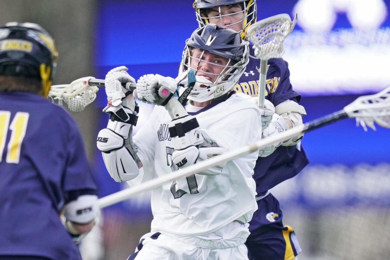 Moses Brown's Peter Sarnowski, center, looks for a shot during Friday's match against Barrington.