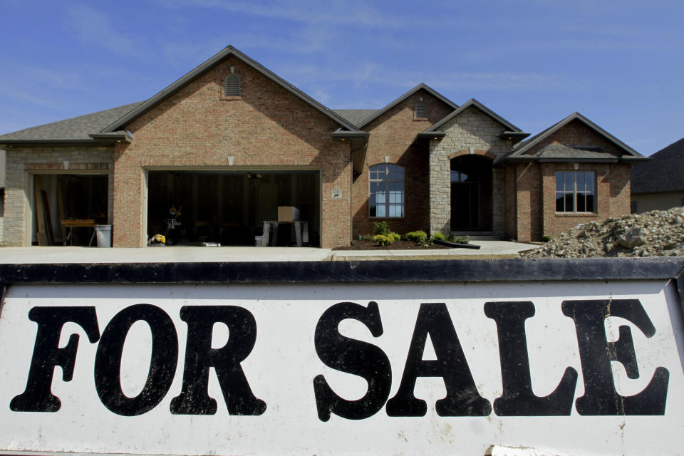 FILE- In this Wednesday, May 23, 2012, file photo, a new home still under construction is seen for sale in Springfield, Ill. Americans signed more contracts to buy previously occupied homes in May, matching the fastest pace in two years. The increase suggests home sales will rise this summer and the modest housing recovery will continue. (AP Photo/Seth Perlman, File)