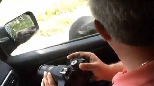 Terrified father drops his camera to slam car door shut. Photo: YouTube