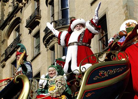 Santa Claus waves as he rides on his float down Central Park West during the 87th Macy's Thanksgiving Day Parade in New York November 28, 2013. REUTERS/Gary Hershorn