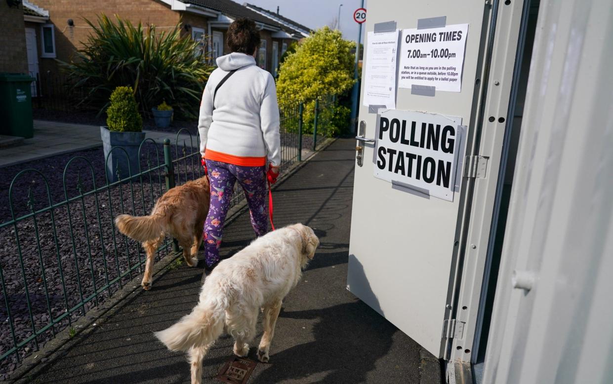 A person voting in person at their local polling station - something Brendan Clarke-Smith thinks should be done by all voters