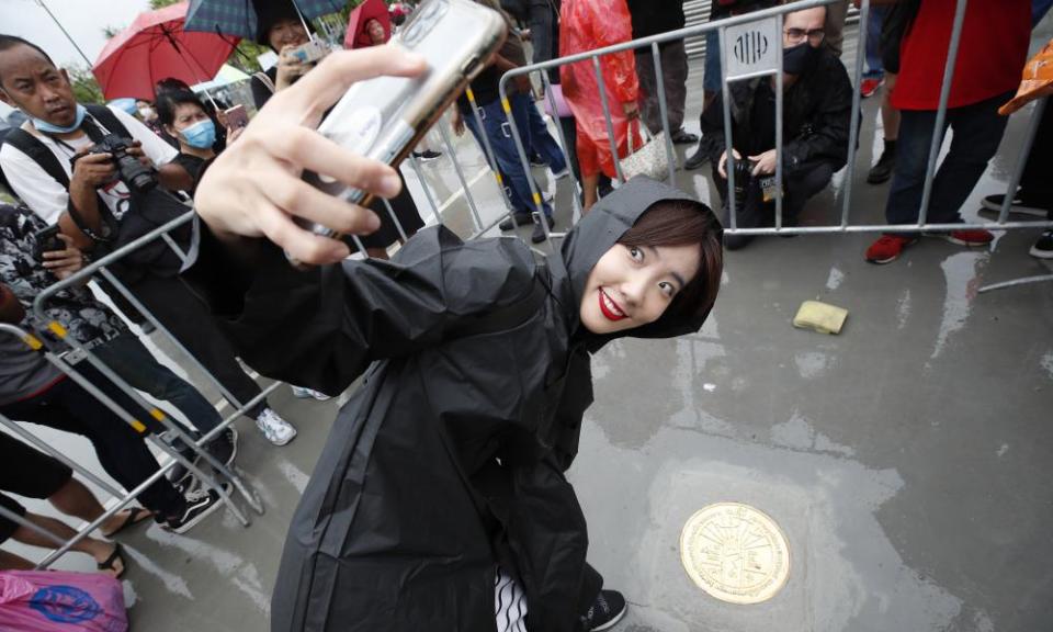 A protester poses with a plaque declaring ‘This country belongs to the people’