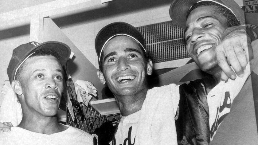 SF.LouMack.4.0108.LM–Dodger shortstop Maury Wills, left pitcher Sandy Koufax, center,and Willie Davis join after winning game 5 against the Minnesota Twins in the 1965 World Series. Koufax pitched a four–hit shutout stiking out 10.Photo/Art by:Lou Mack