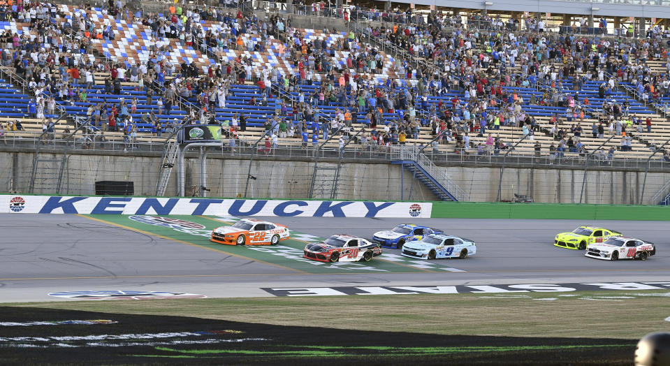 Austin Cindric (22) leads the field across the line at the start of the NASCAR Xfinity Series auto race at Kentucky Speedway in Sparta, Ky., Friday, July 12, 2019. (AP Photo/Timothy D. Easley)