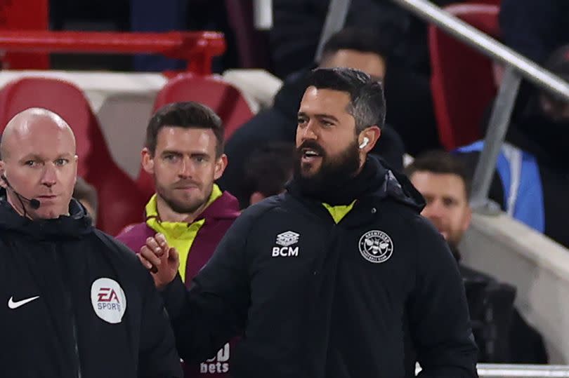 Jurgen Klopp (L) clashes with Bernardo Cueva (R) during Liverpool's clash with Brentford.