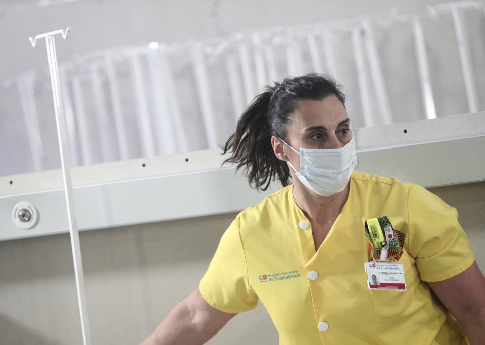 MADRID, SPAIN - MARCH 30: A nurse is seen carrying material while installing a campaign hospital that will admit 50 beds, helping to alleviate pressure on the Hospital of Fuenlabrada in the fight against coronavirus and will directly connect to the Oncology section on March 30, 2020 in Madrid, Spain. (Photo by Eduardo Parra/Europa Press via Getty Images)