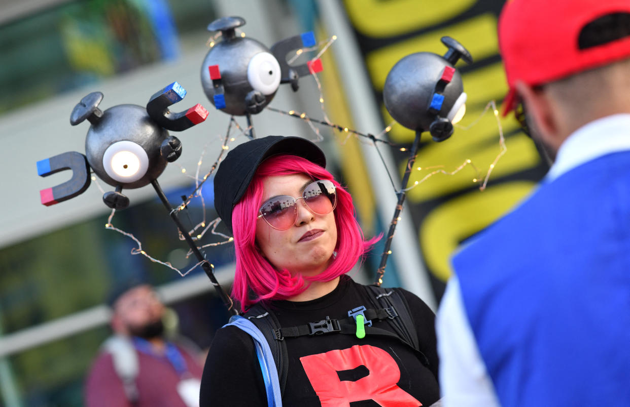 A cosplayer dressed as a member of Team Rocket from the anime Pokemon.