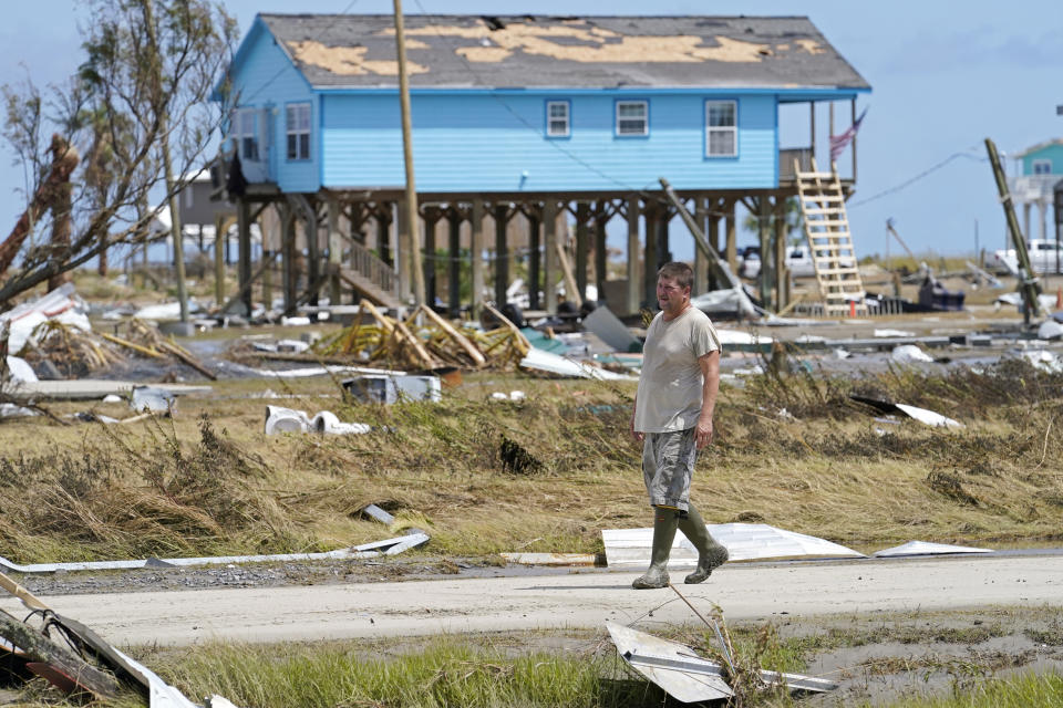 Jim Venissat, who's camp was destroyed by Hurricane Laura, walks amid the devastation in Holly Beach, La., Saturday, Aug. 29, 2020. (AP Photo/Gerald Herbert)