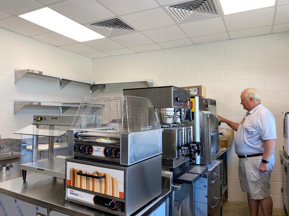 Etowah County Mega Sports Complex Authority Chairman Ralph Burke looks over newly installed kitchen equipment in the concession stand.