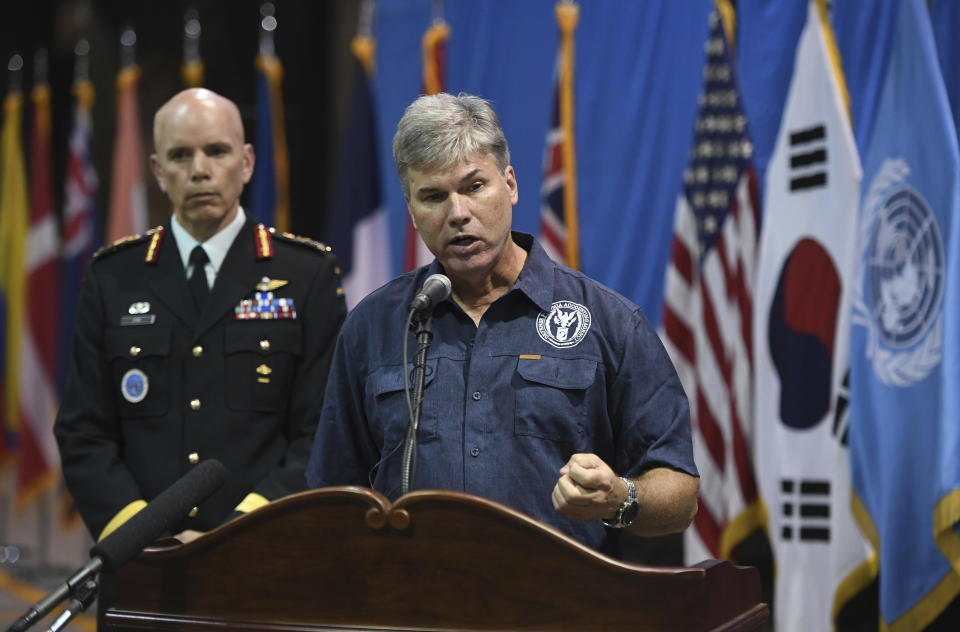 John Byrd, director of scientific analysis at the Defense POW/MIA Accounting Agency (DPAA), center, speaks as U.S. Lieutenant General Wayne Eyre, deputy commander of the United Nations Command, looks on before a repatriation ceremony for the remains of U.S. soldiers killed in the Korean War and collected in North Korea, at the Osan Air Base in Pyeongtaek, South Korea, Wednesday, Aug. 1, 2018. North Korea handed over 55 boxes of the remains last week as part of agreements reached during a historic June summit between its leader Kim Jong Un and U.S. President Donald Trump. (Jung Yeon-je/Pool Photo via AP)