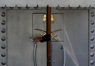 A consulate official hands over a Turkish ID card to a member of security staff at the entrance of Saudi Arabia's consulate in Istanbul, Turkey October 10, 2018. REUTERS/Murad Sezer