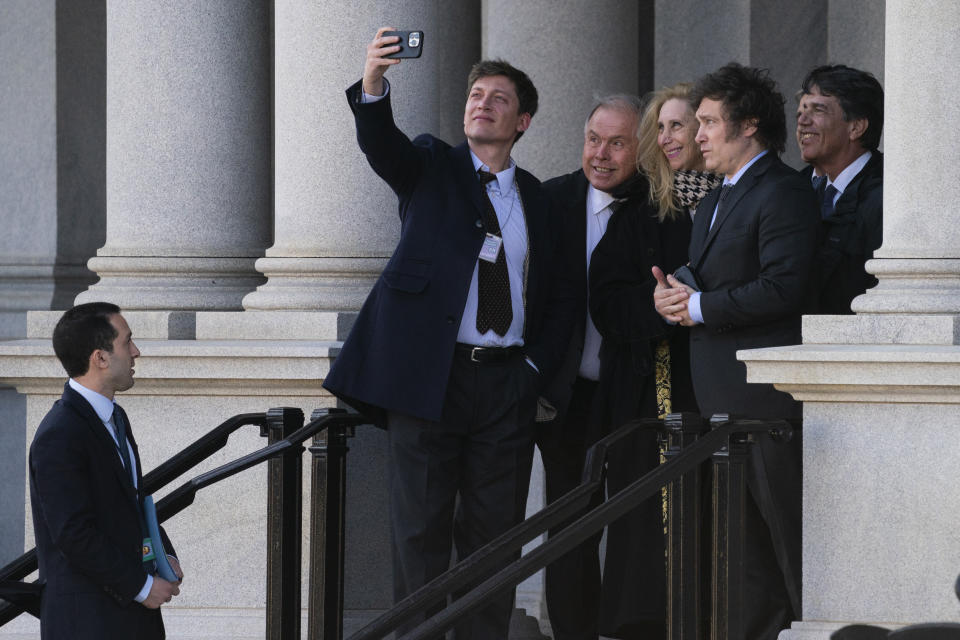 Argentina's President-elect Javier Milei poses for a photo on the steps of the Eisenhower Executive Office Building on the White House campus after a meeting with National Security Adviser Jake Sullivan, Tuesday, Nov. 28, 2023, in Washington. (AP Photo/Evan Vucci)