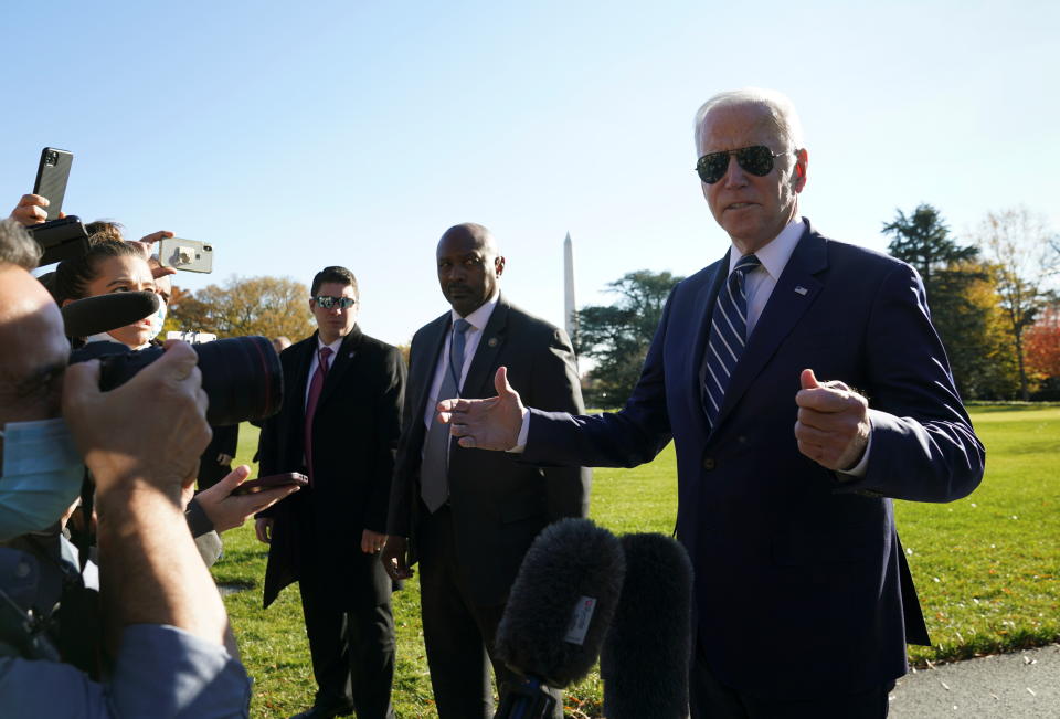 President Biden, walking toward the White House, speaks to reporters.